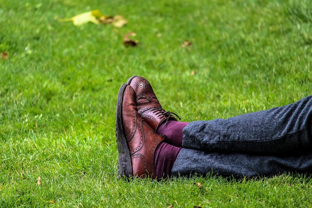 Free legs crossed on grass image, public domain relax CC0 photo.