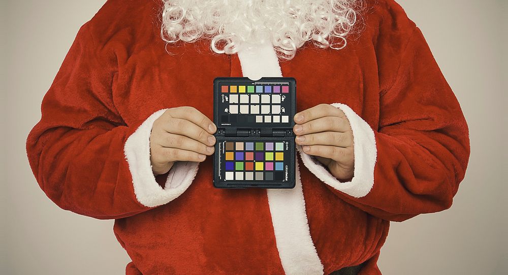 Free Santa Claus holding color palette image, public domain Christmas CC0 photo.