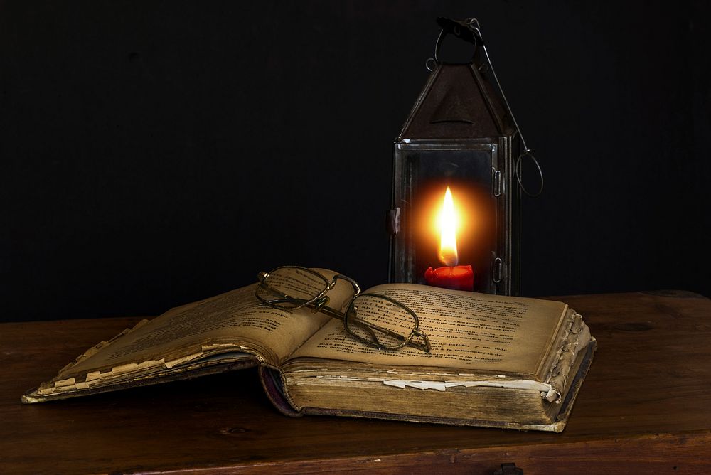 Free old book with glasses inside and lantern in background image, public domain CC0 photo.