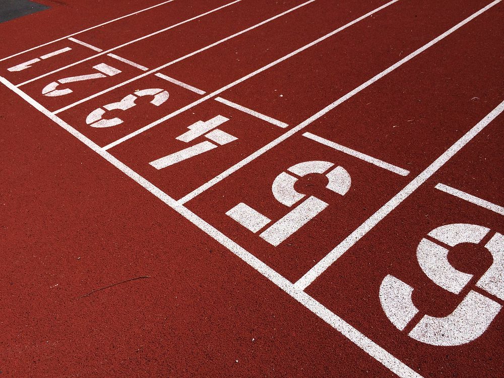 Free close up texture of running track surface with numbers photo, public domain sport CC0 image.