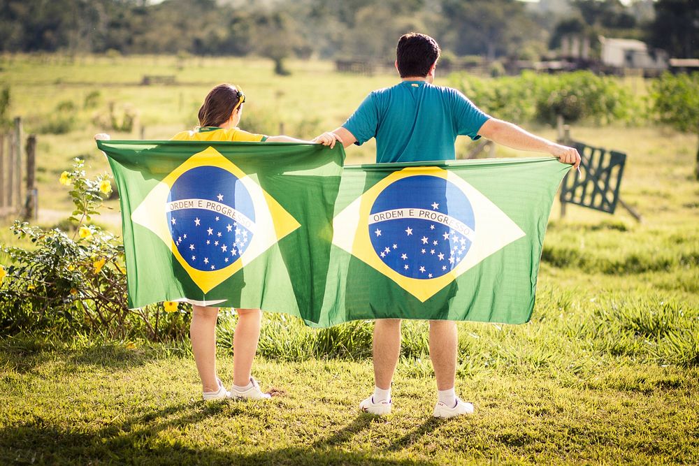 Man & woman holding Brazil flag image, free public domain CC0 photo.