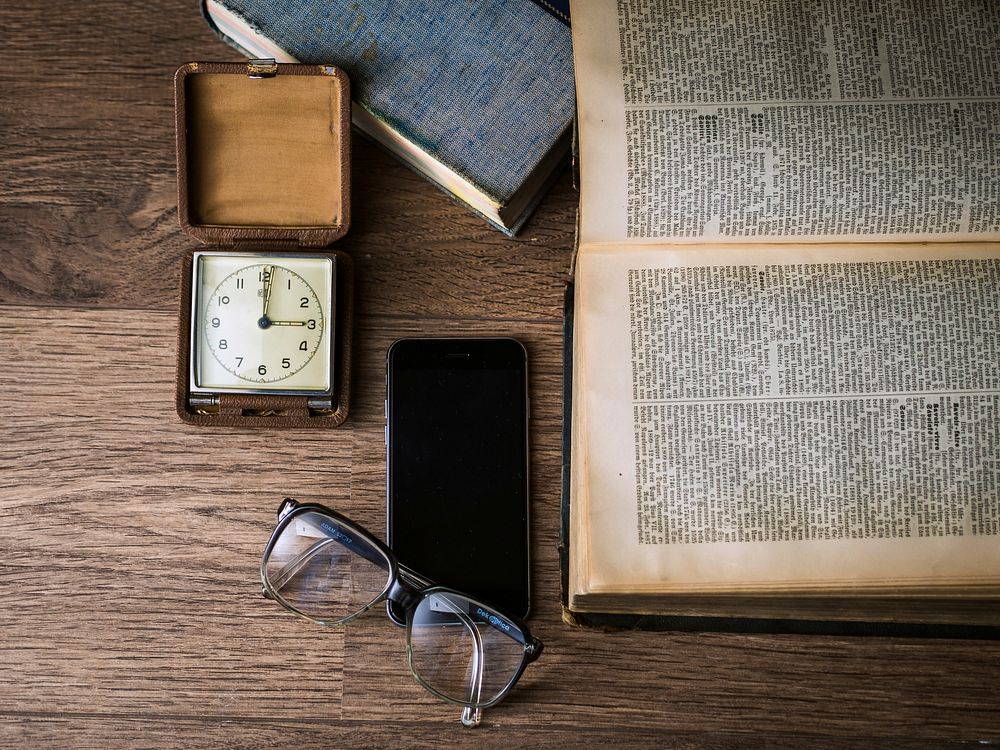 Free reading table with book, clock, phone and glasses image, public domain CC0 photo.