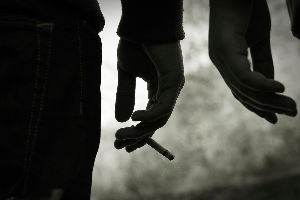 Silhouette of a person with a cigarette and friend Free public domain CC0 photo.