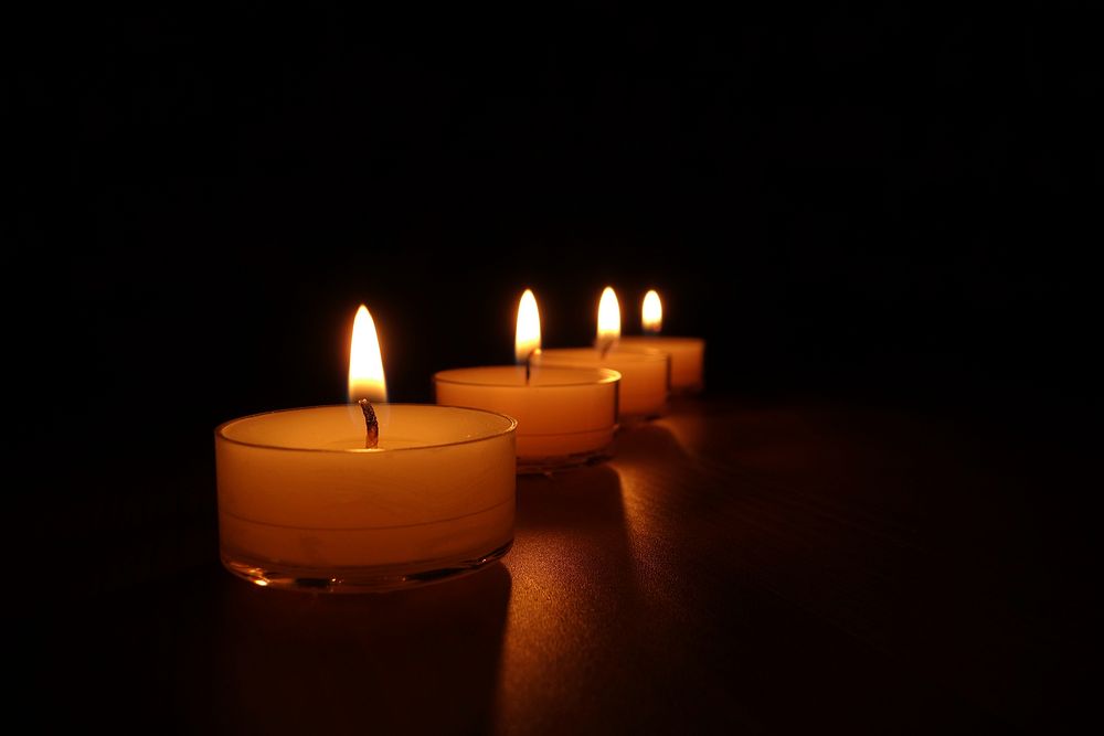 Free candle lights fire in dark background photo, public domain CC0 image.