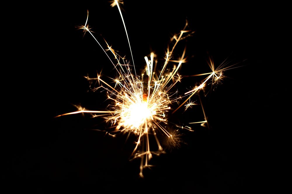 Free burning sparkler on a black background image, public domain CC0 photo.