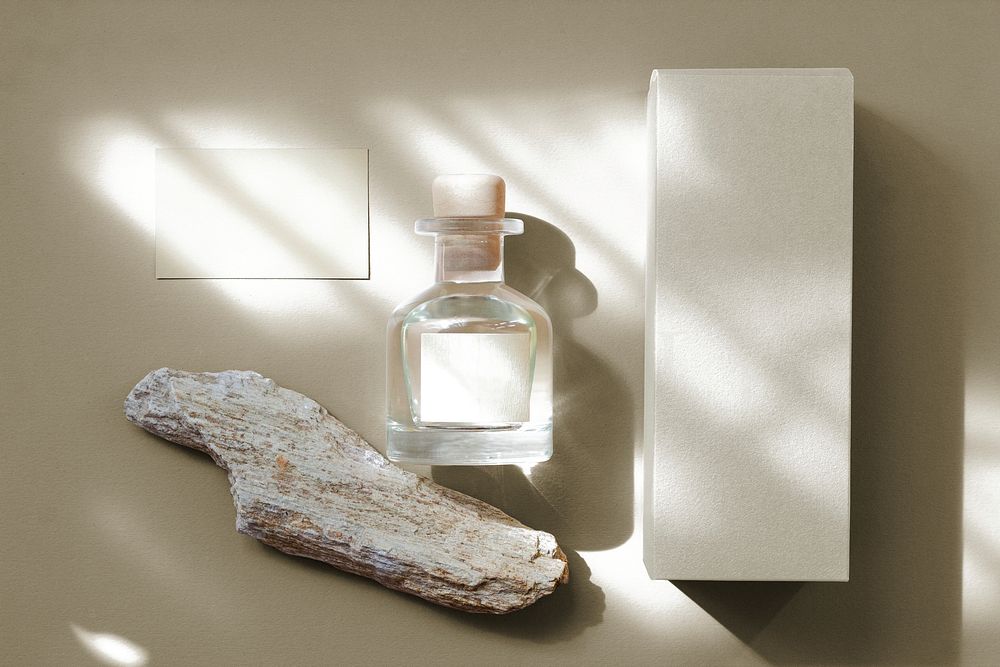 Aesthetic perfume bottle flat lay, blank white label, business branding design