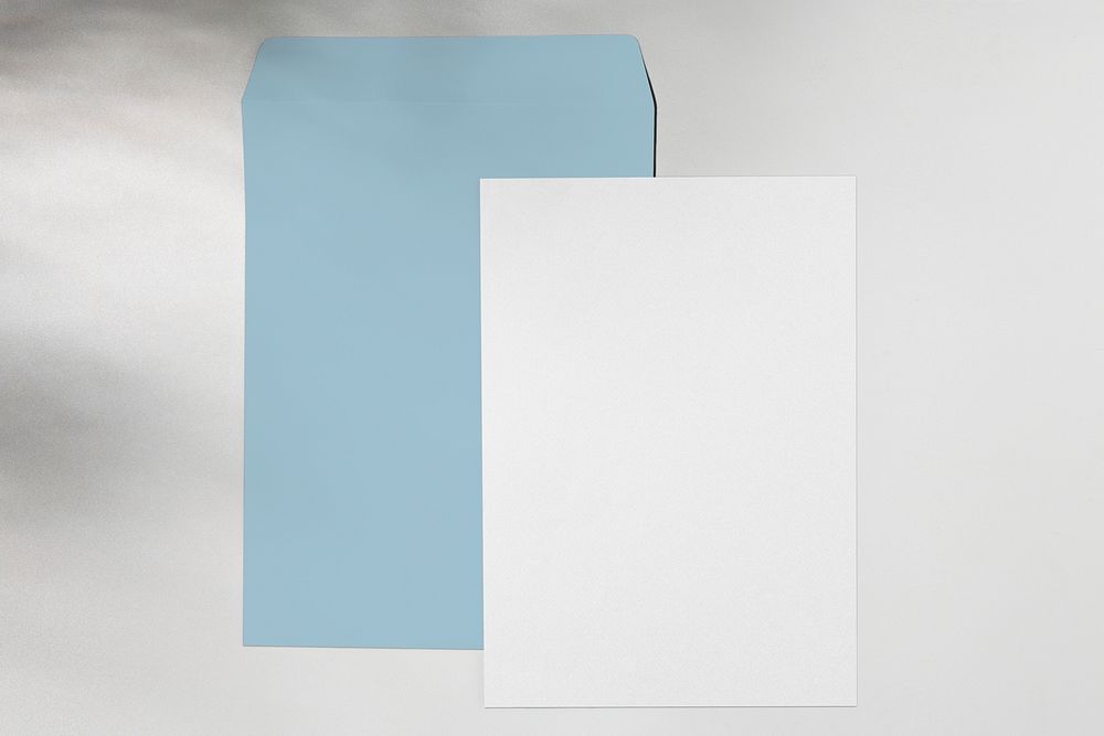 White paper, blue envelope, corporate identity, flat lay design