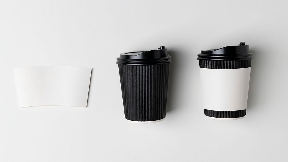 Black coffee cup and white paper sleeve, product packaging, flat lay design