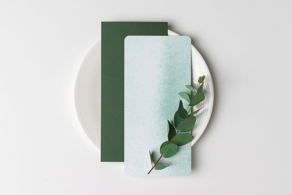 Aesthetic menu cards on white plate, table setting flat lay