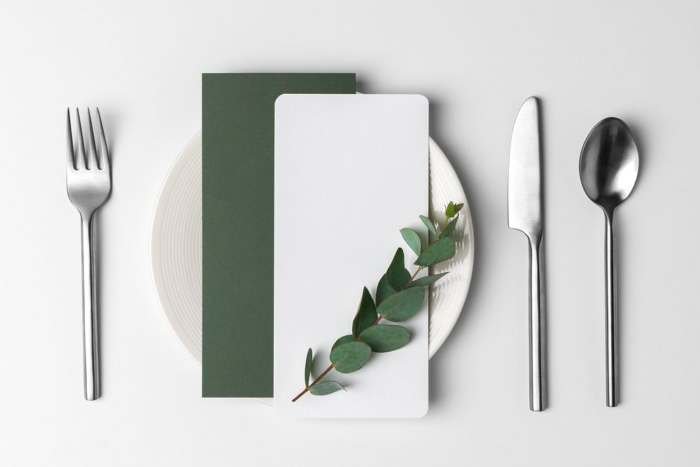 Aesthetic menu cards on white plate, table setting flat lay