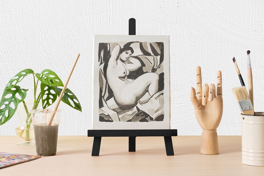 Painted canvas on easel, wood hand mannequin, drawing class decoration
