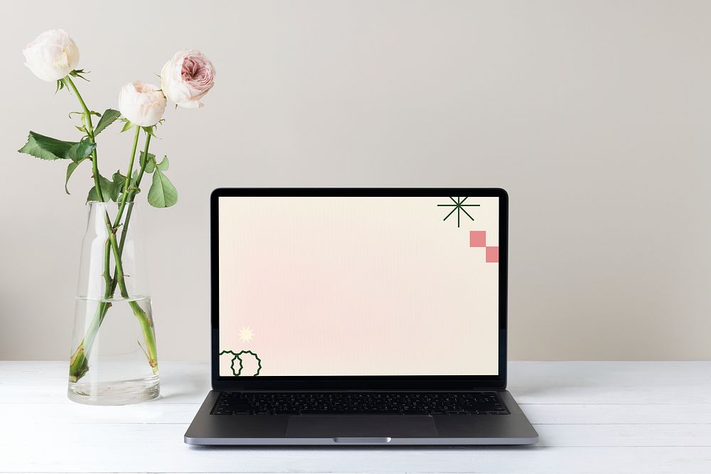 Aesthetic workspace with laptop and flower in vase