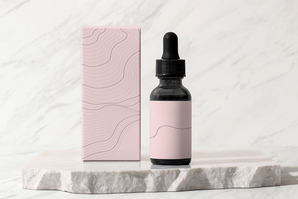 Beauty serum dropper bottle, pink paper box, skincare product packaging