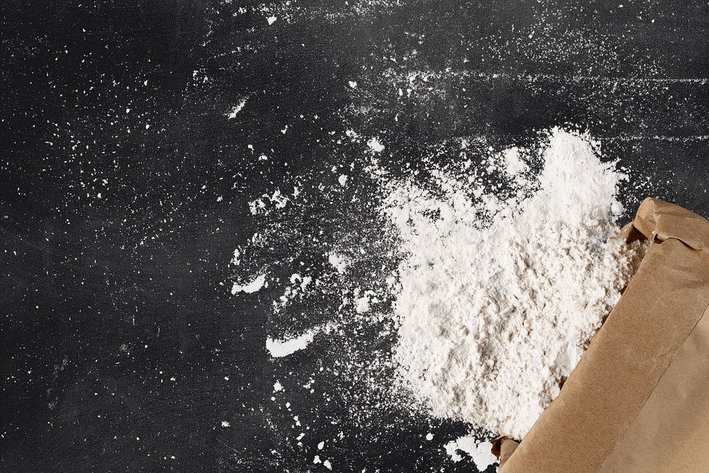 Flour texture, black background, cooking concept