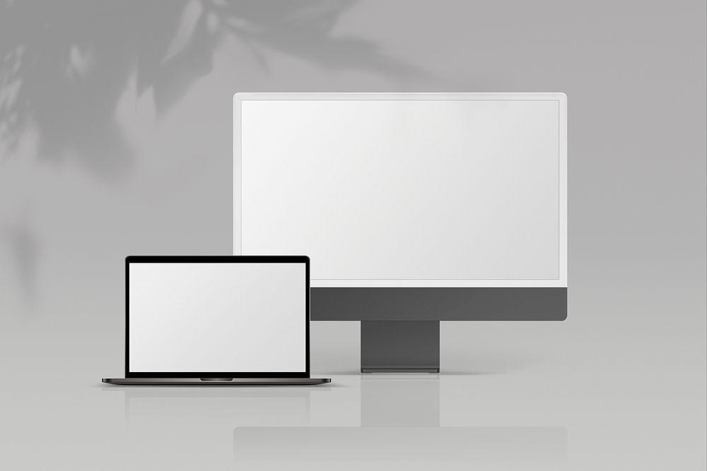 Gray laptop and desktop computer, empty white screens