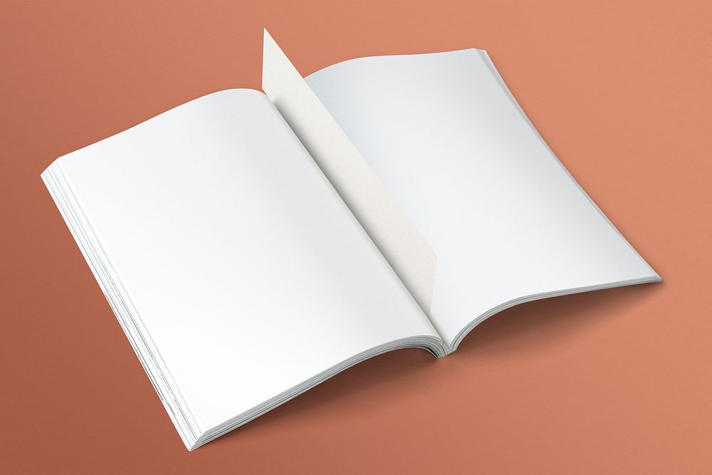 Open blank book on orange background