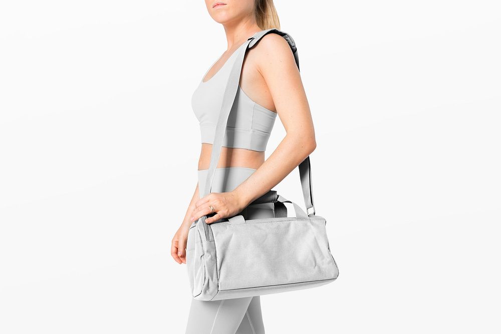 Sportive woman with gray duffle bag