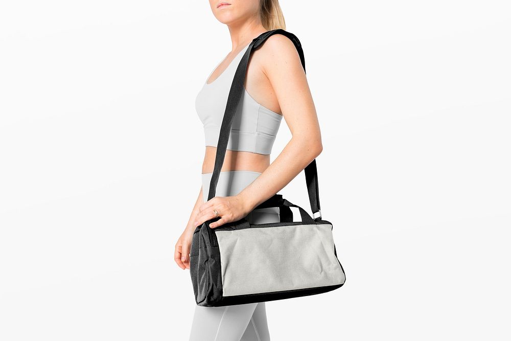 Sportive woman with black and gray duffle bag