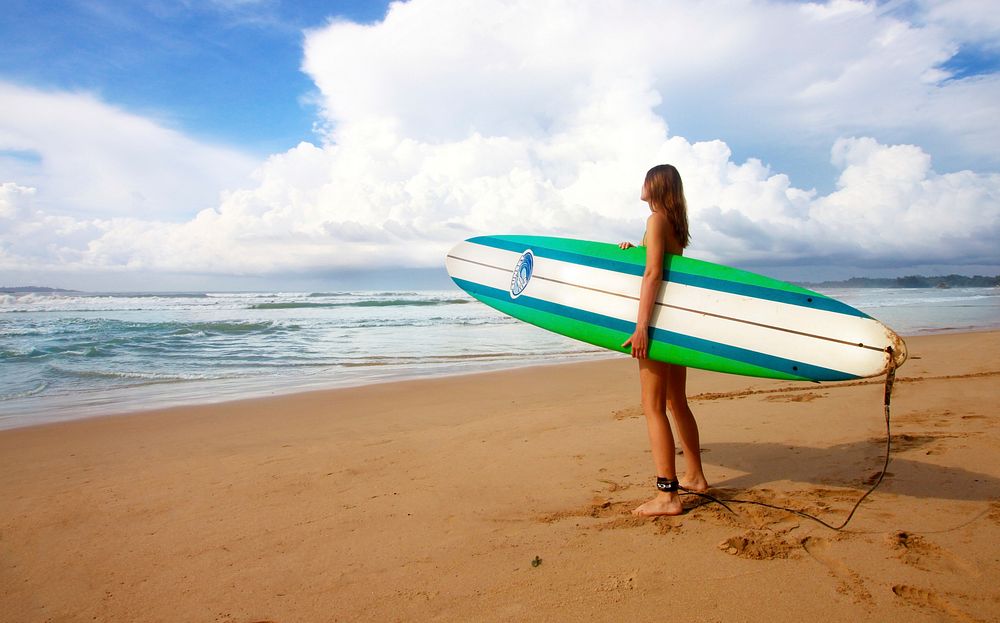 Free surfer girl on beach photo, public domain sport CC0 image.