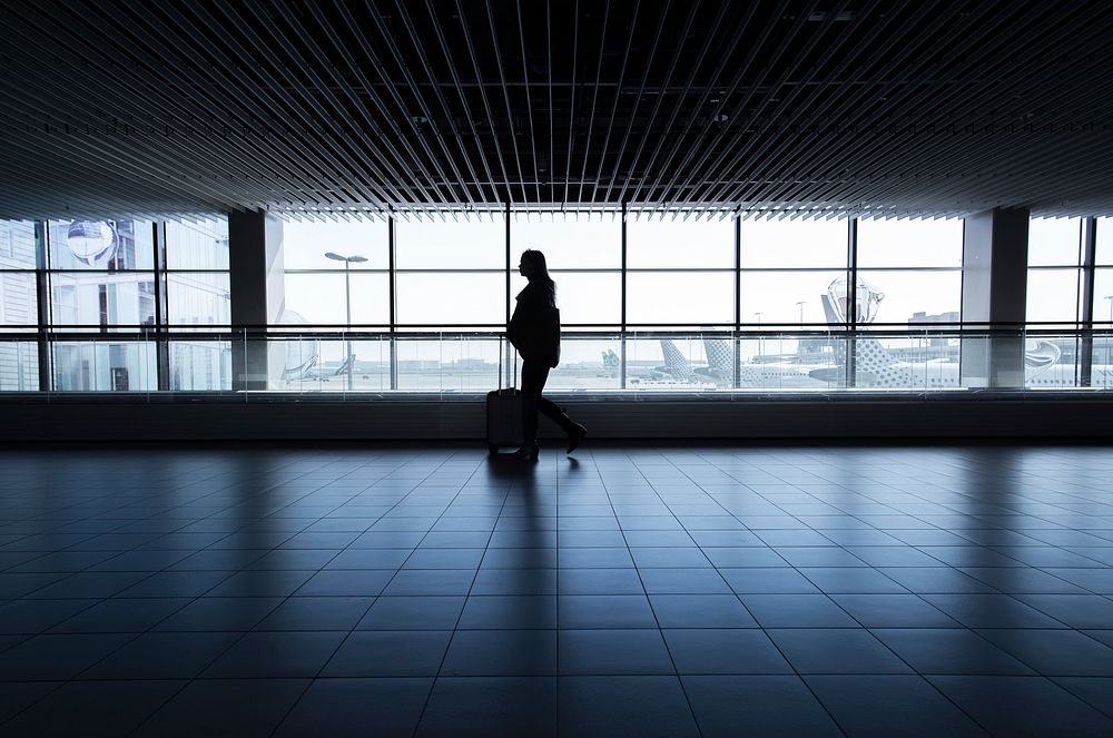 Lady walking in airport alone, free public domain CC0 photo