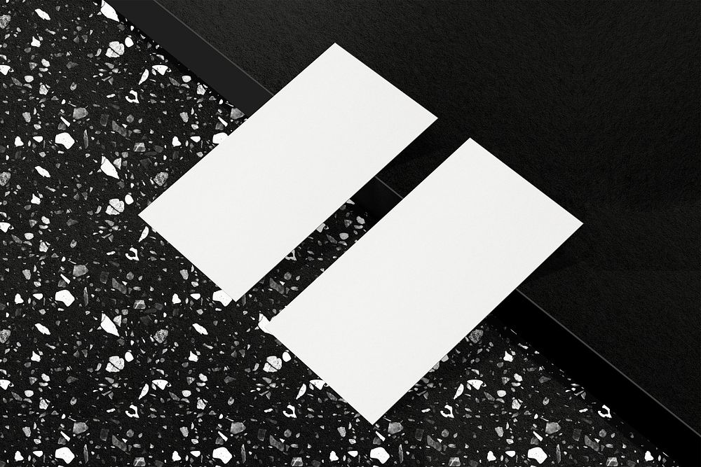 Blank business card on black terrazzo floor 