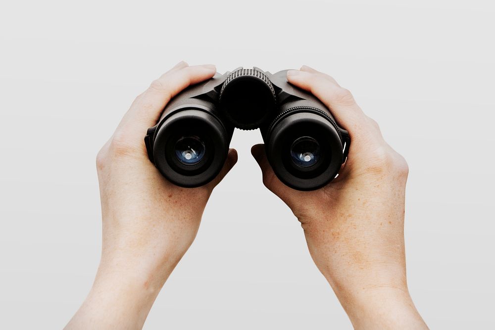 Spy holding binoculars, isolated on white