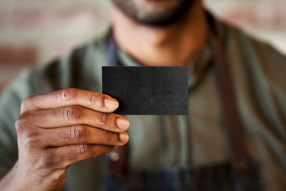 Barber showing black blank business card small business entrepreneur