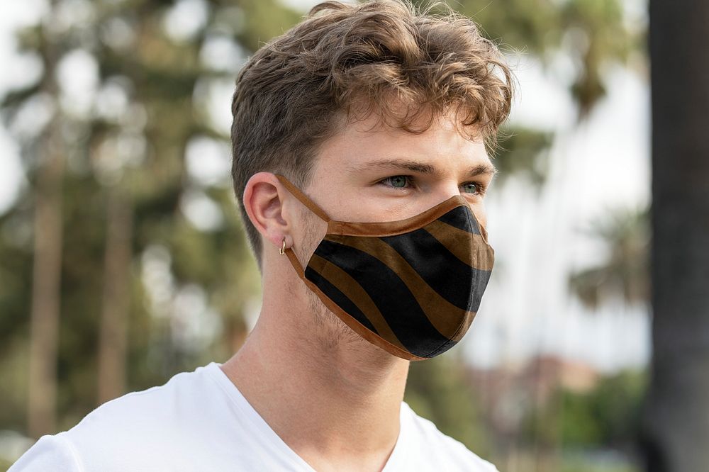 Man wearing face mask in park, the new normal lifestyle, summer time