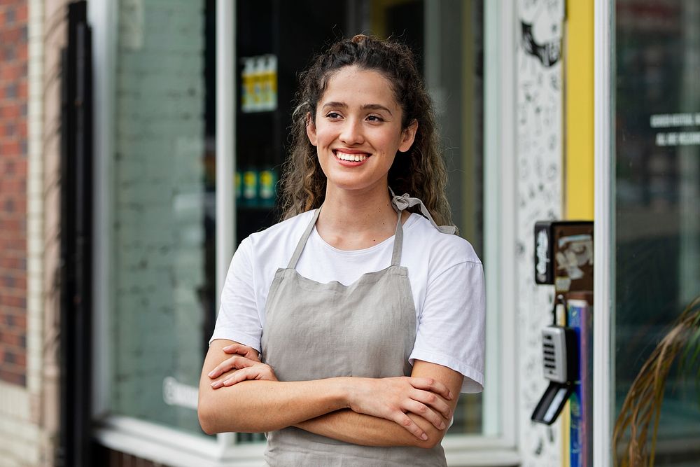 Cheerful small business owner in beige apron