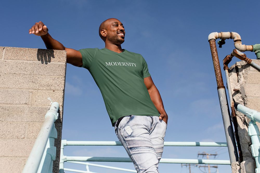 Happy African American man posing, wearing green tee