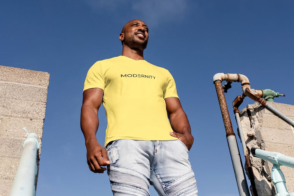 Confident African American man posing, wearing yellow tee