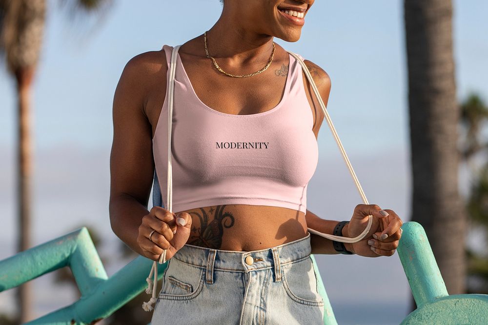Woman wearing pastel pink top at the Venice beach, modernity text