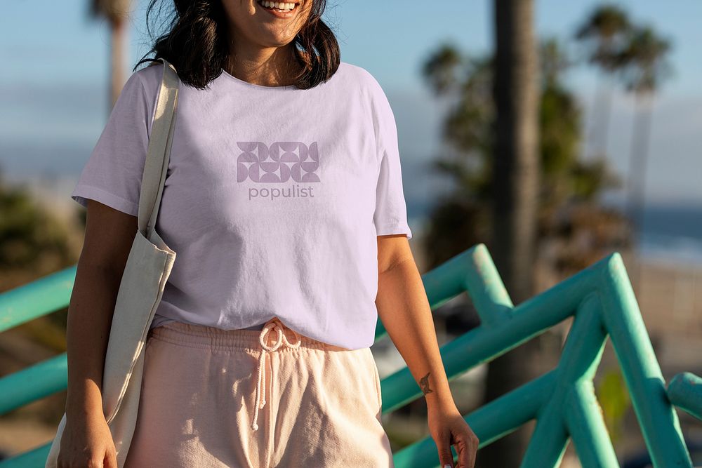 Woman wearing a casual outfit, lilac purple shirt with abstract design & text populist