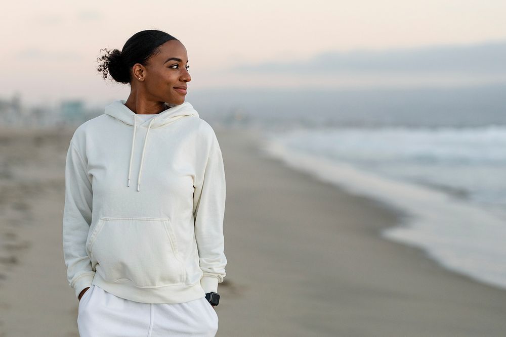 Beautiful woman at the beach, wearing plain white hoodie