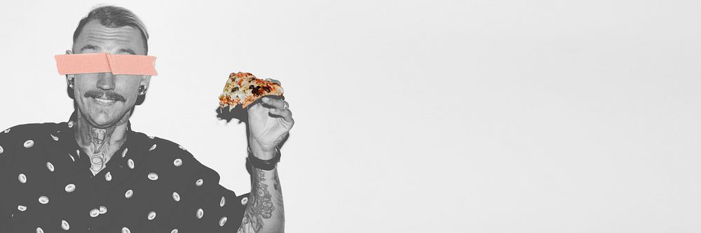 Tattooed man holding a pizza in his hand