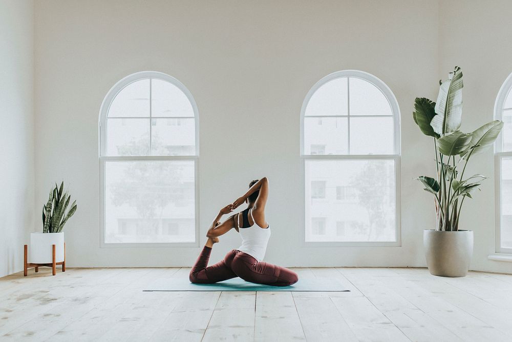 Black woman doing a Naginyasana pose