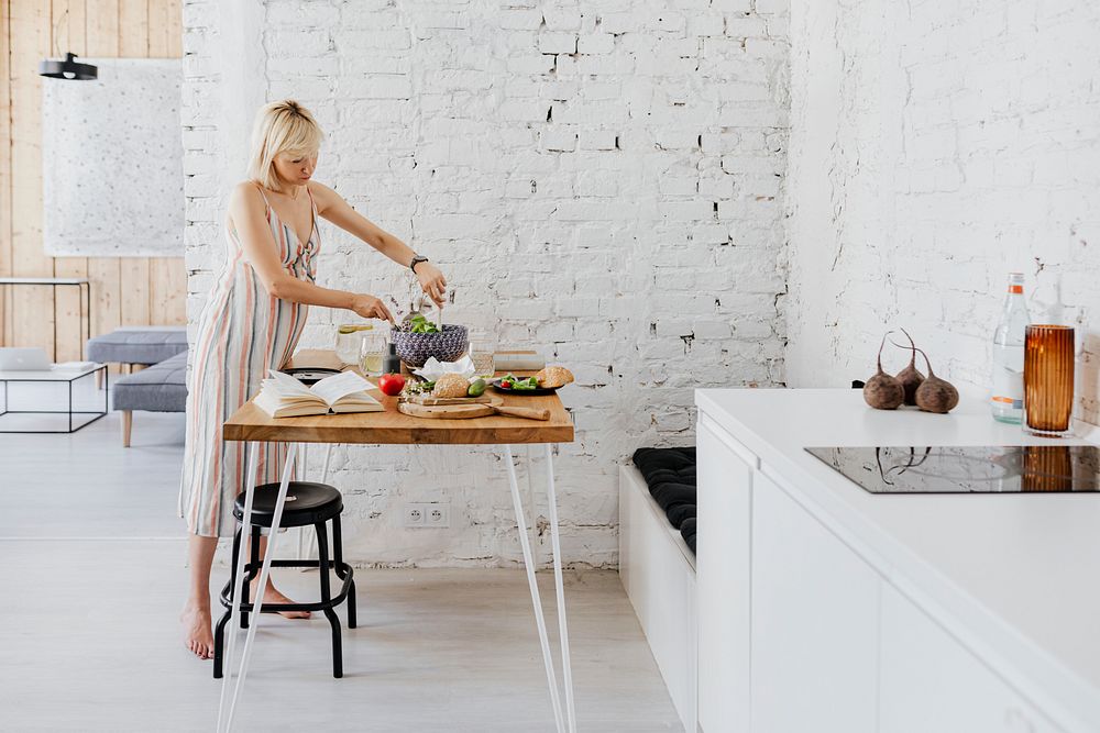 Expecting mother preparing salad in the kitchen