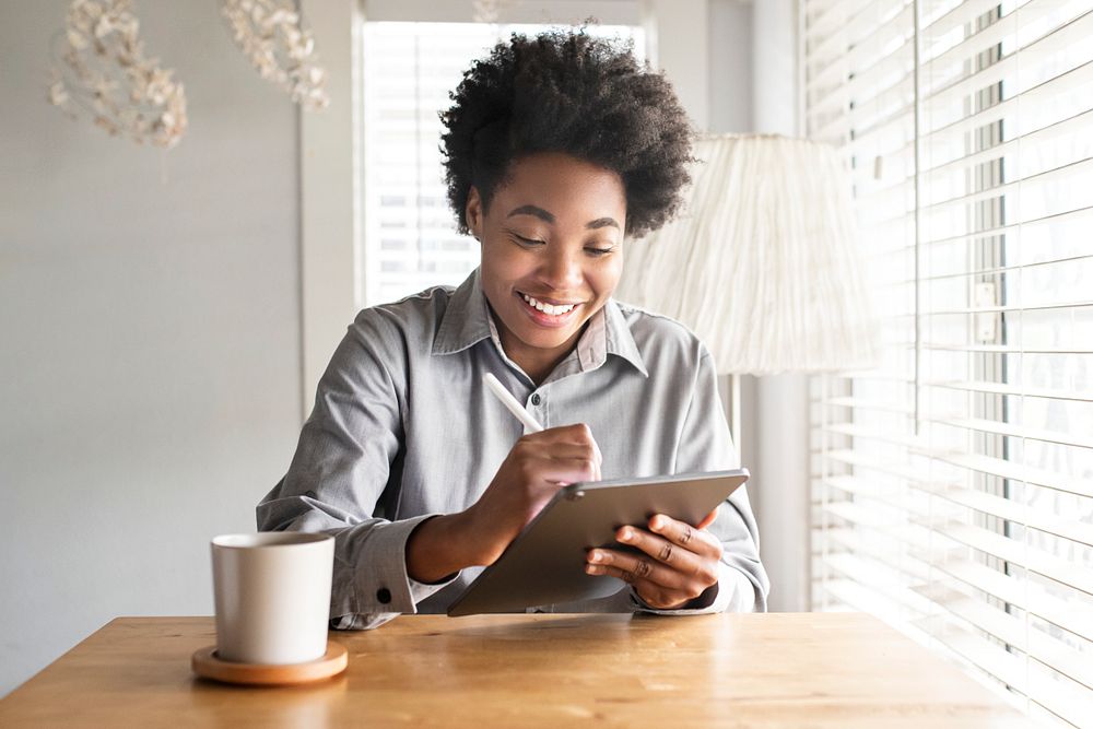 Woman working on a digital tablet in the new normal