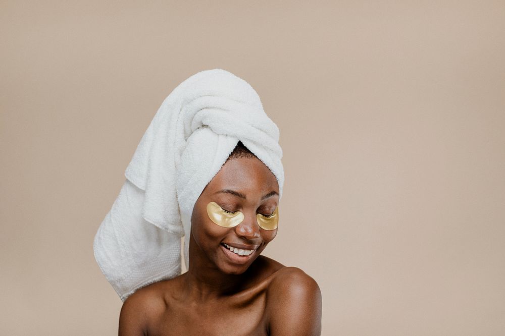 Happy black woman wearing a golden eye mask