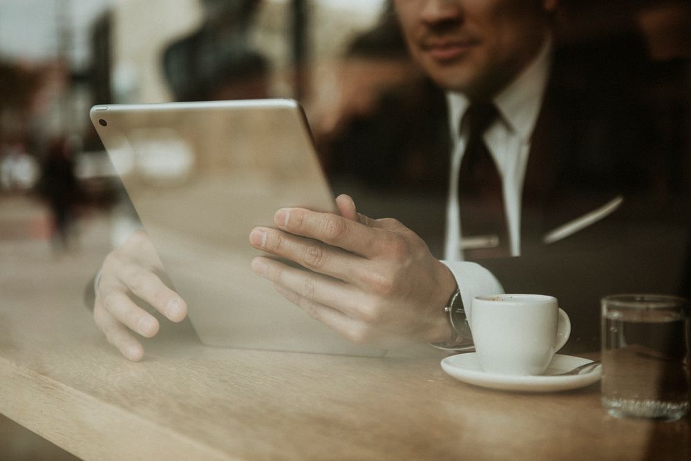 Businessman in a cafe using a tablet