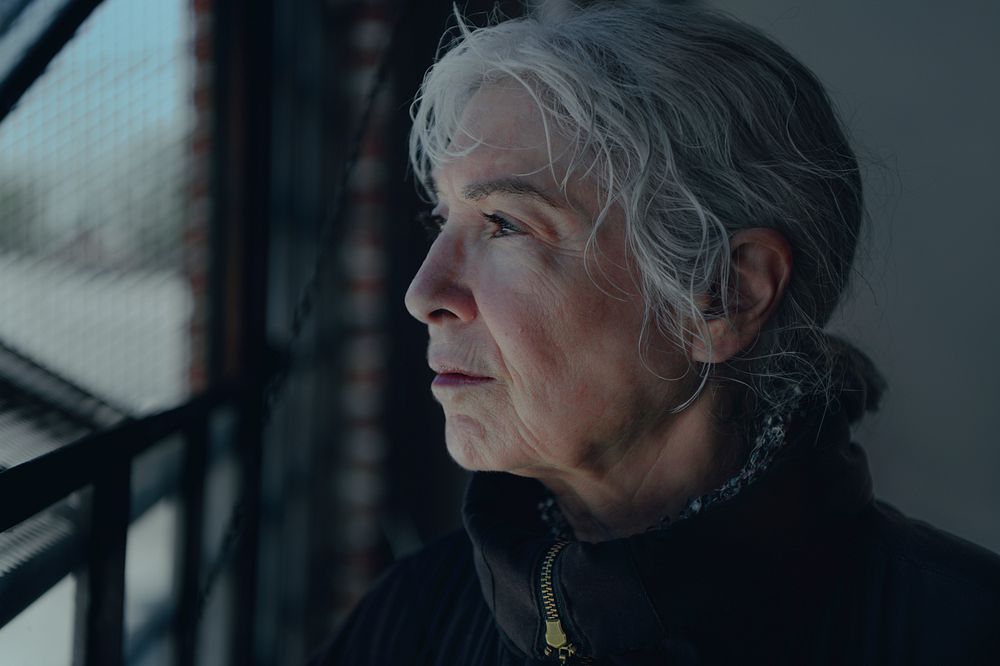 Abandoned elderly woman in a cold winter day