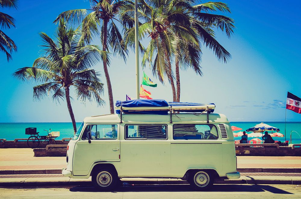 Classic caravan parked in front of the beach. Original public domain image from Wikimedia Commons