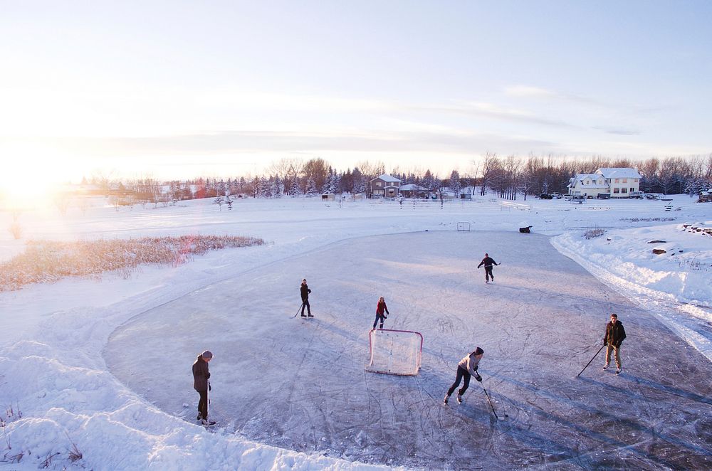 Group of people playing ice hockey with one net on a frozen surface in a suburb. Original public domain image from Wikimedia…
