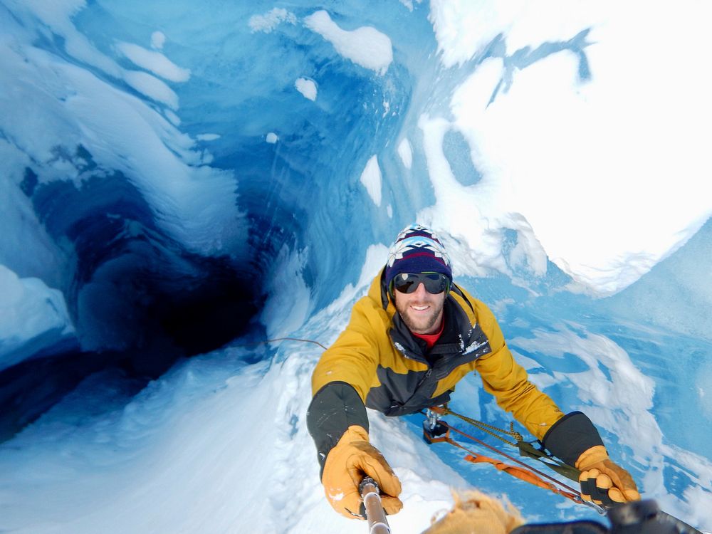 Man climbing alone on a snowy mountain, Tongass National Forest. Original public domain image from Flickr