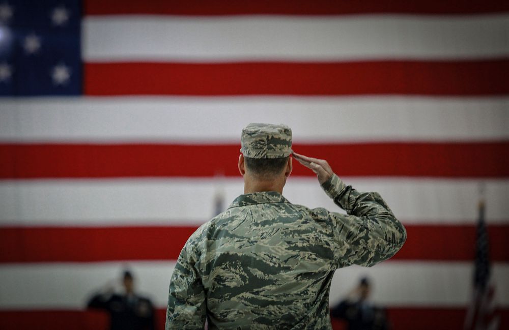 soldiers saluting the flag