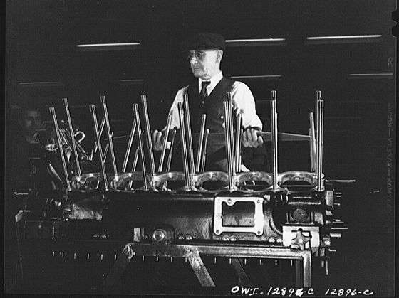 Detroit, Michigan. Assembly of Rolls Royce engines at the Packard motor car company. Checking alignment of the studs.…