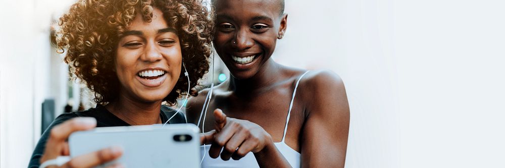 Happy women laughing at a digital tablet