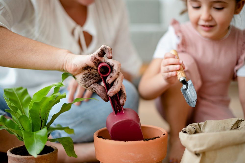 Kid DIY plant potting at home with mom