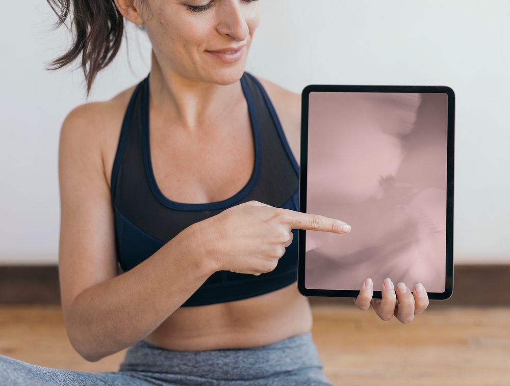 Yoga instructor showing a digital tablet mockup mobile phone wallpaper