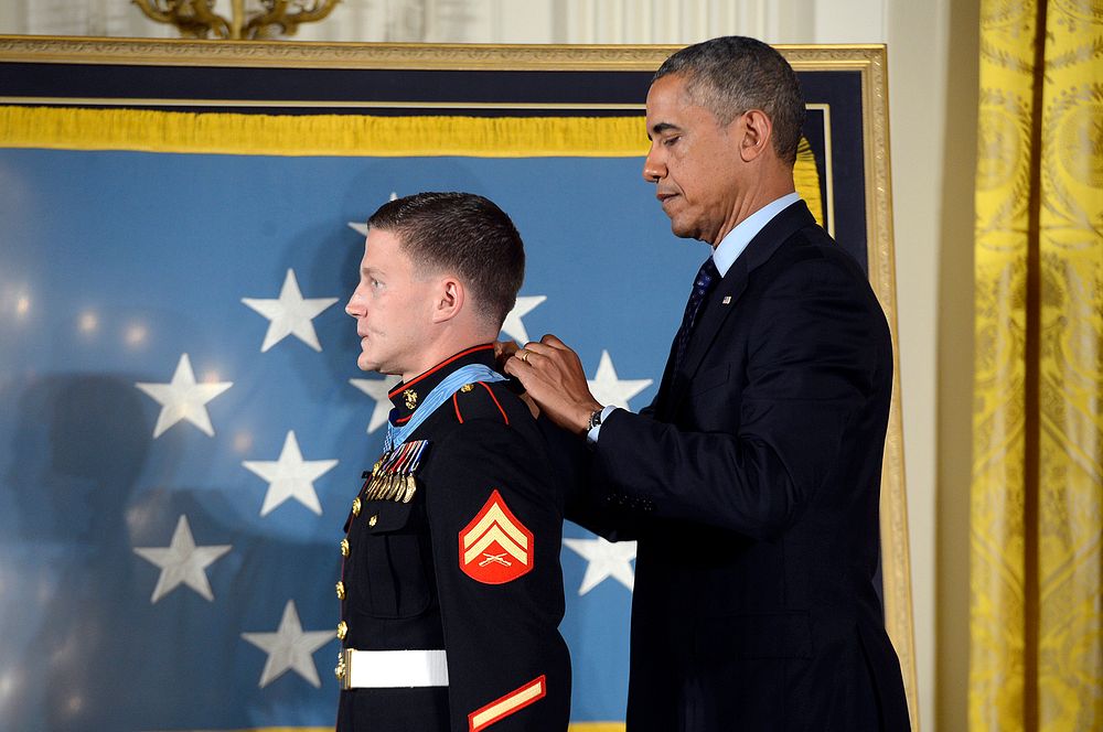 President Barack Obama, right, awards the Medal of Honor to retired U.S. Marine Corps Cpl. William Carpenter during a…
